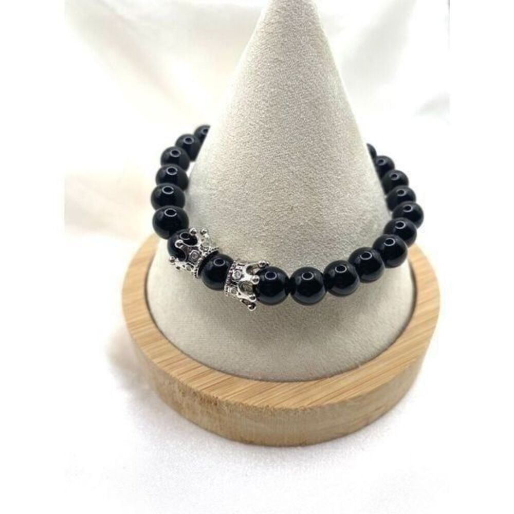 Jet black round glass beaded stretch bracelet with silver toned crown charm